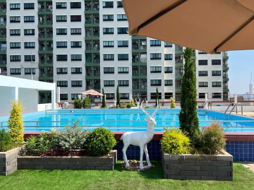 a statue of a deer in front of a swimming pool at Elizabeth Hotel in Bangkok