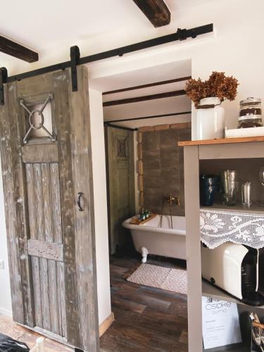 an open door into a bathroom with a bath tub at Csipke Somló Vendégház in Somlóvásárhely