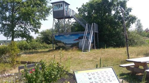 a park with a playground with a staircase and a house at EnJoy Meer und See Ferienhaus -In Lauwersoog- 1-6 Pers- 3 Schlafzimmer in Lauwersoog