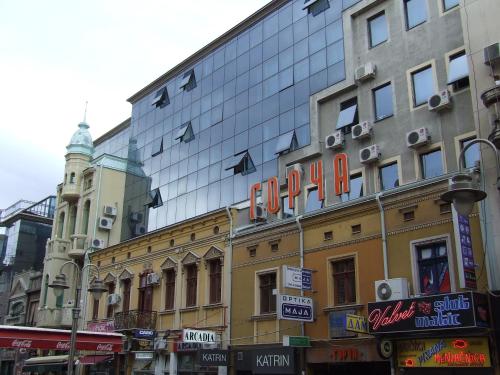 a building with a sign on the side of it at Diamond Apartments Niš in Niš