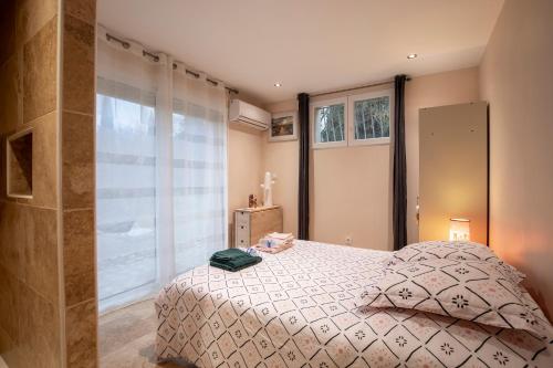 um quarto com uma cama e uma janela em Au son des cigales em Avignon