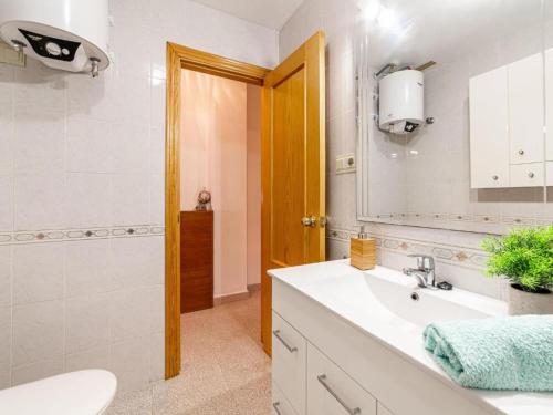 a bathroom with a sink and a toilet and a mirror at CABO DE LAS ÁGATAS in El Cabo de Gata