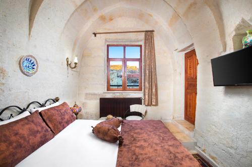 Postel nebo postele na pokoji v ubytování Romantic Cave Hotel