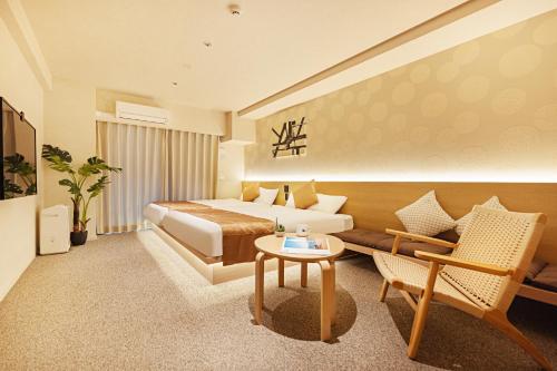 a hotel room with a bed and a couch at Apartment Hotel 11 Namba in Osaka