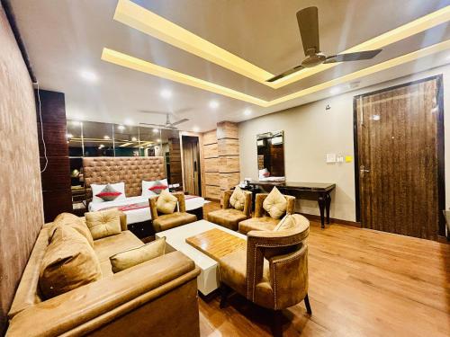 a living room with a couch and a piano at Hotel Gold Souk - Karol Bagh in New Delhi
