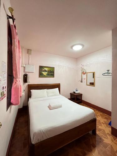 a bedroom with a large white bed in a room at Happy in Pai in Pai