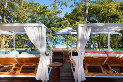 a deck with chairs and umbrellas at W Costa Rica Resort – Playa Conchal in Playa Conchal