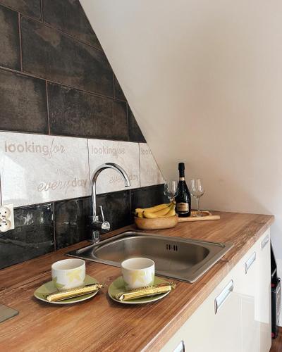 a kitchen counter with two cups and a sink at HELLO GIEWONT in Zakopane