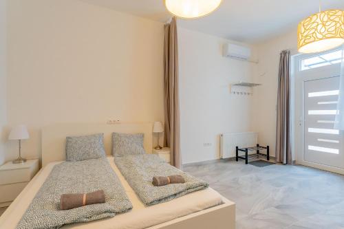 a bedroom with a bed with two pillows on it at Gardencity Villa Apartman in Budapest