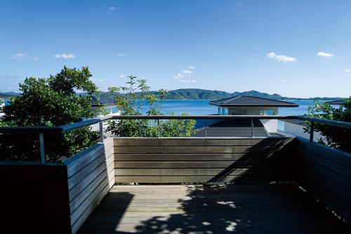 a staircase leading to a house with a view of the water at Miru Amami in Tatsugo