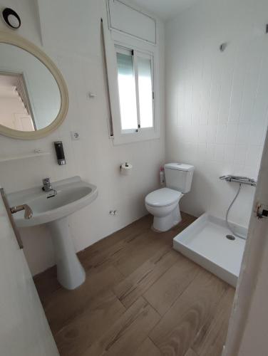 a bathroom with a sink and a toilet and a mirror at Estancia Rural Tranquila in Lliçà d'Amunt