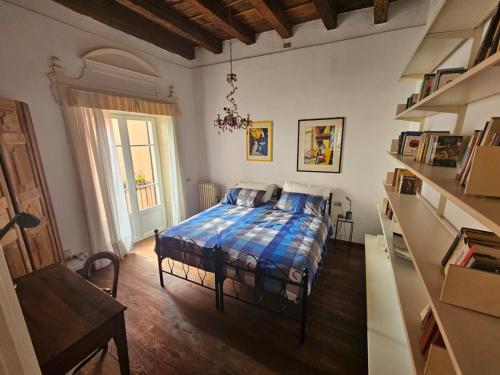 a bedroom with a bed with a blue comforter at Il Cortiletto- Le Piazze in Brescia