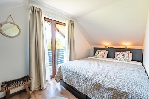 a bedroom with a bed and a large window at Holiday home Villa Antique in Bjelovar