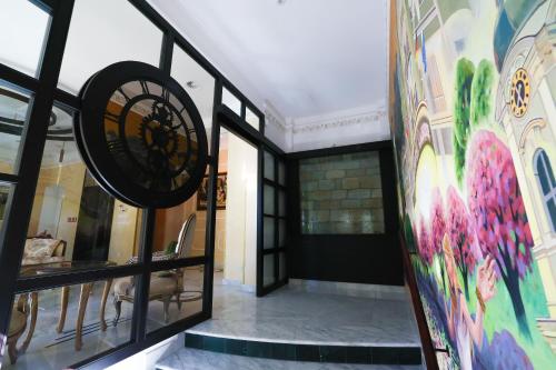 a hallway with a mural on the wall at Boutique Hotel Ambiente ****+ in Karlovy Vary