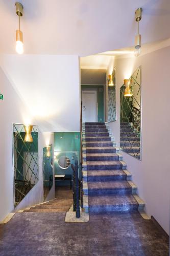 a stairway in a building with a blue staircase at Boutique Hotel Ambiente ****+ in Karlovy Vary