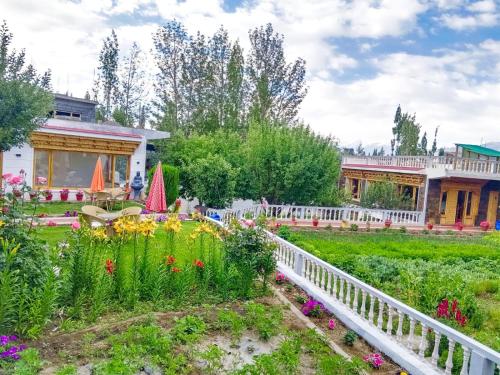 a garden with flowers in front of a building at Kidar in Leh