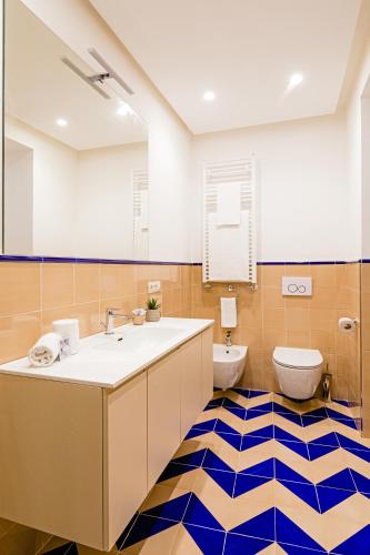 a bathroom with a sink and a toilet at Hotel Da Raffaele in Ischia
