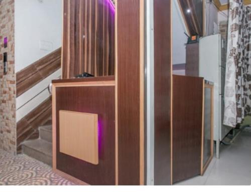 a wooden elevator in a room with stairs at Hotel City Plaza in Bangalore