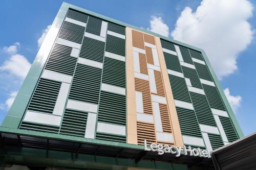 a building with brown and white shutters on it at The Legacy Hotel Nana Sukhumvit, Aspira Collection in Bangkok