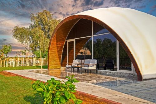 a gazebo with chairs and tables in a yard at Nirvana Retreat By Patanjali Wellness Initiative in Ras al Khaimah