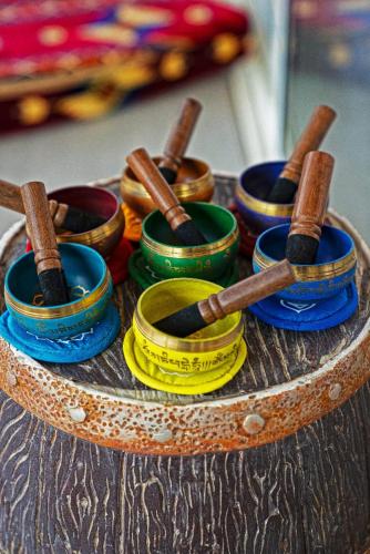 a bunch of different colored bowls and sticks on a table at Nirvana Retreat By Patanjali Wellness Initiative in Ras al Khaimah