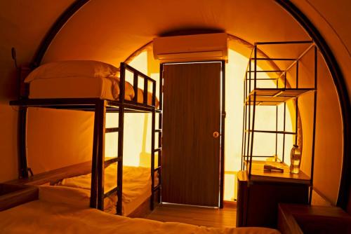 a room with two bunk beds and a doorway at Nirvana Retreat in Ras al Khaimah