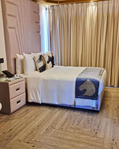 a bedroom with a bed and a dresser with a bear on it at Nirvana Retreat By Patanjali Wellness Initiative in Ras al Khaimah