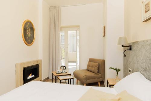 a living room with a chair and a fireplace at Le Corti - Dimora storica in Polistena