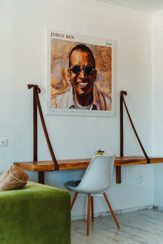 a painting of a man with sunglasses on a wall at Beachfront Marilyn in Durrës