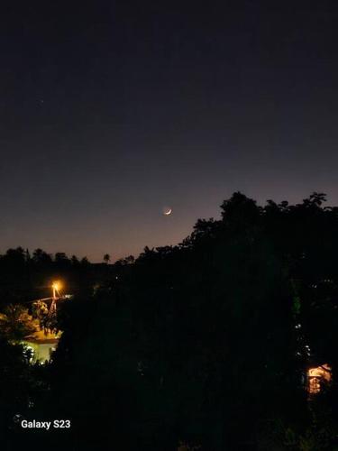 a view of the moon over a river at night at RefleXion Views in Belle Garden