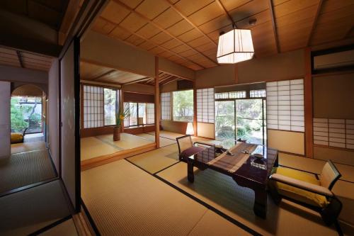 an asian living room with a table and chairs at 天童荘 TENDOSO in Tendo