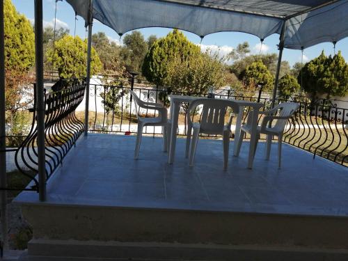 a white table and chairs sitting on a patio at Cozy Rodas House 1 in Skála