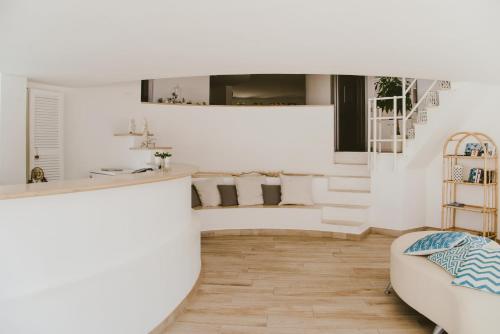 a living room with white walls and a staircase at Residence Altair - Serra degli Alimini in Otranto