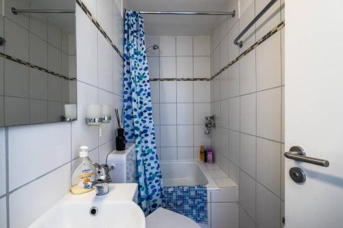 a bathroom with a sink and a tub and a shower at Newly renovated apartment in Bernau im Schwarzwald