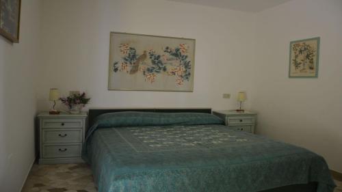 a bedroom with a bed and two night stands at Bright villa in Caorle with private garden in Caorle