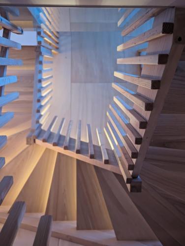 a wooden staircase in a building with lights on it at Chalet Coste Belle in La Fare-en-Champsaur