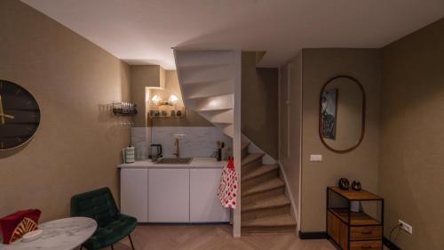 uma casa de banho com um lavatório e uma escada num quarto em Downtown Suite em Haia