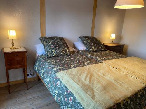 a small bedroom with a bed and two night stands at Chambre 2 in Chalmazel Jeansagniere