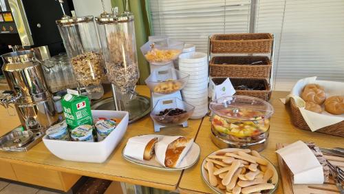 a table with various food items on it at Pension Sonnengarten & Therme included - auch am An- & Abreisetag! in Lutzmannsburg