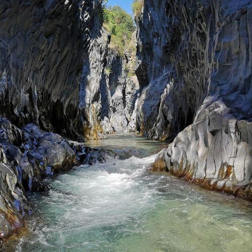 a painting of a river in a rocky canyon at La Coccinella in Graniti