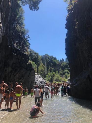 a large group of people walking in the water at La Coccinella in Graniti