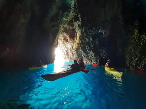 a group of people on kayaks in a cave at La Coccinella in Graniti