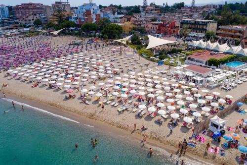 a beach with a large group of umbrellas at La Coccinella in Graniti