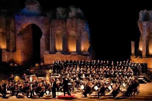 a large orchestra playing in front of a building at La Coccinella in Graniti