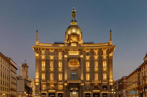 a building with a clock tower on top of it at Palazzo Cordusio, a Gran Melia Hotel in Milan
