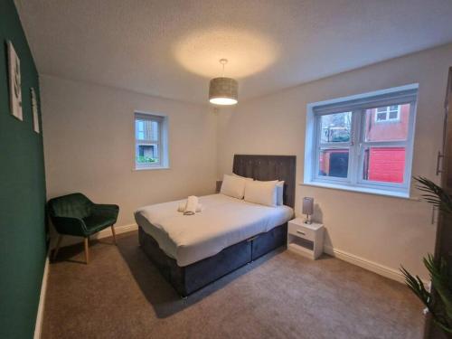 a bedroom with a bed and a chair and a window at Free Parking: Perfect City Centre Flat in Manchester
