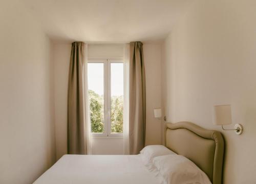 a bedroom with a bed and a window at Residence Altair - Serra degli Alimini in Otranto