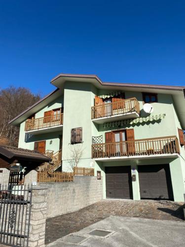 a building with balconies on the side of it at Affittacamere Il Pettirosso in Moggio Udinese