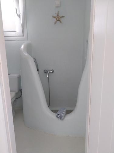 a white bath tub in a bathroom with a starfish at Altana Boutique Hotel in Tinos Town