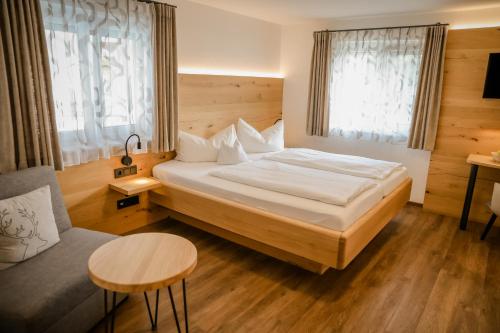 a hotel room with a bed and a table at Landhotel Schellenberg in Überlingen